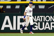 Texas Rangers center fielder Michael Helman (24) reacts after making a leaping catch at the...