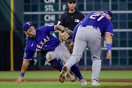 Texas Rangers second baseman Cody Freeman, left, and first baseman Jake Burger (21) collide...