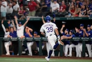 Texas Rangers' Cody Freeman celebrates as he sprints past the dugout after hitting a two-run...