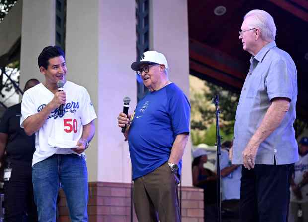 Mario Lopez, left, speaks with former Dodger announcer Jaime Jarrin,...
