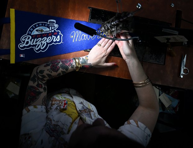 Tina Vines uses a 1910 Cornely sewing machine to embroider...