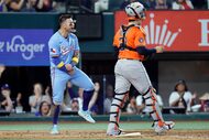 Texas Rangers Cody Freeman (left) reacts after scoring on a Josh Jung double in the sixth...