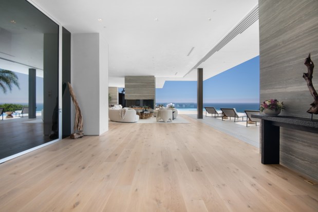 Open floor plan living room with open floor-to-ceiling windows.