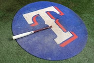 The bat of the Texas Rangers Jake Burger rests in the on deck circle before baseball game...