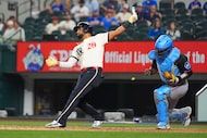Miami Marlins catcher Brian Navarreto, right, reacts after Texas Rangers' Ezequiel Duran...