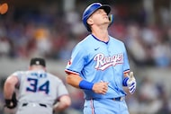 Texas Rangers third baseman Josh Jung reacts after grounding out with runners in scoring...