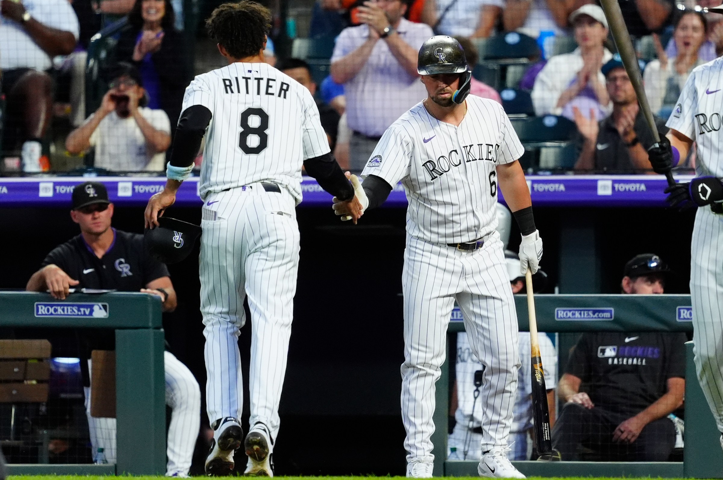 Jun 11, 2025; Denver, Colorado, USA; Colorado Rockies shortstop Ryan Ritter (8) is congratulated for scoring a run by designated hitter Kyle Farmer (6) in the sixth inning against the San Francisco Giants at Coors Field. Mandatory Credit: Ron Chenoy-Imagn Images