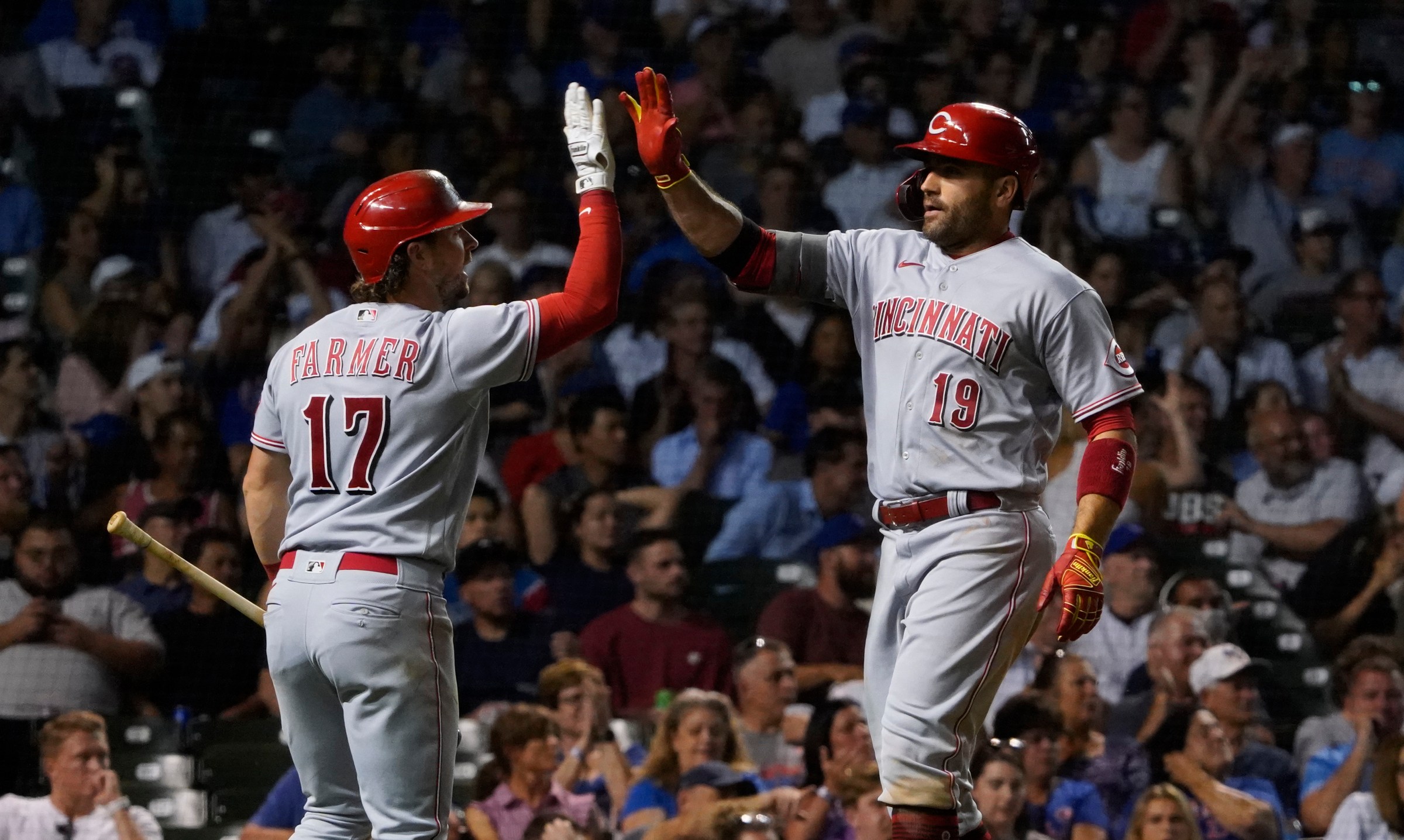 Jun 30, 2022; Chicago, Illinois, USA; Cincinnati Reds first baseman Joey Votto (19) is greeted by shortstop Kyle Farmer (17) after hitting a home run against the Chicago Cubs during the sixth inning at Wrigley Field. Mandatory Credit: David Banks-Imagn Images