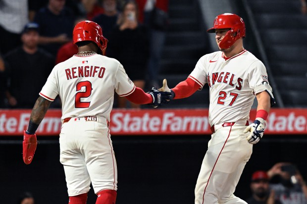 Angels star Mike Trout, right, celebrates with teammate Luis Rengifo...