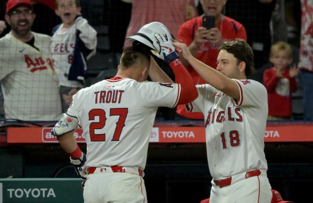 Angels star Mike Trout, left, is congratulated by teammate Nolan...