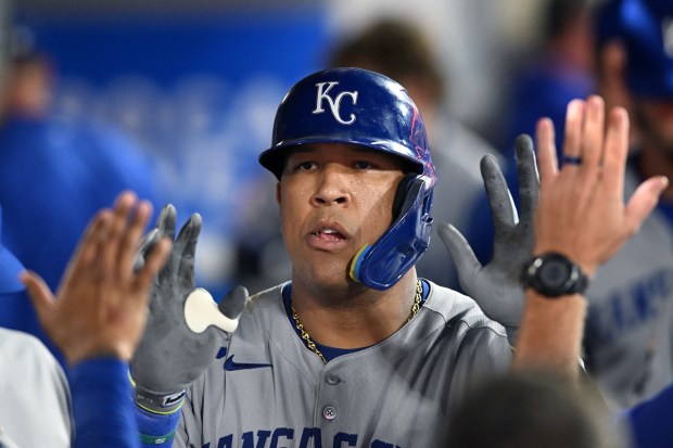 The Kansas City Royals’ Salvador Perez celebrates in the dugout...