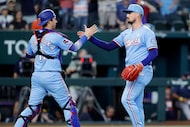 Texas Rangers closing pitcher Shawn Armstrong (right) and catcher Kyle Higashioka (11) slap...