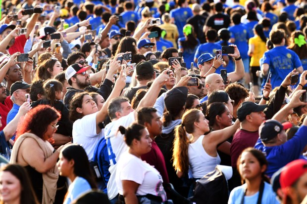 Supporters gather to watch the 5K race during the 12th...