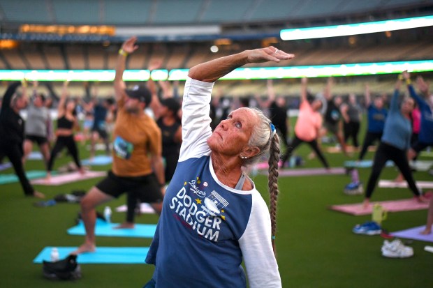 Yoga enthusiasts take to the outfield at Dodger Stadium as...