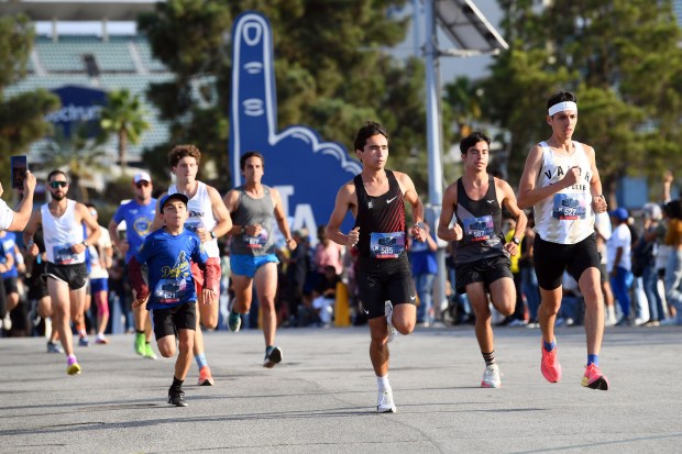Lead runners in the 5K race make their way around...