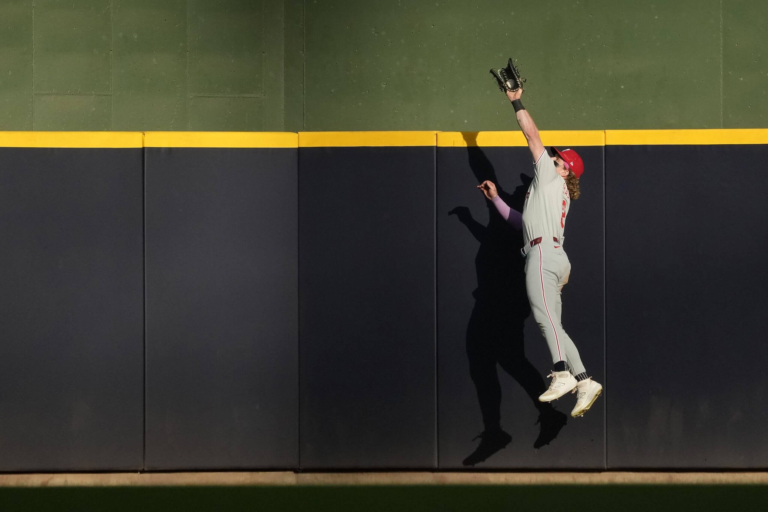 Harrison Bader catches a fly ball hit over the center-field wall at American Family Field.