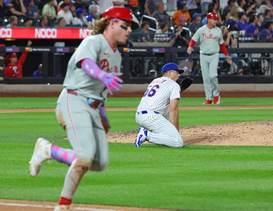 New York Mets pitcher Ryan Helsley (56) gives up a game-tying run to Harrison Bader.
