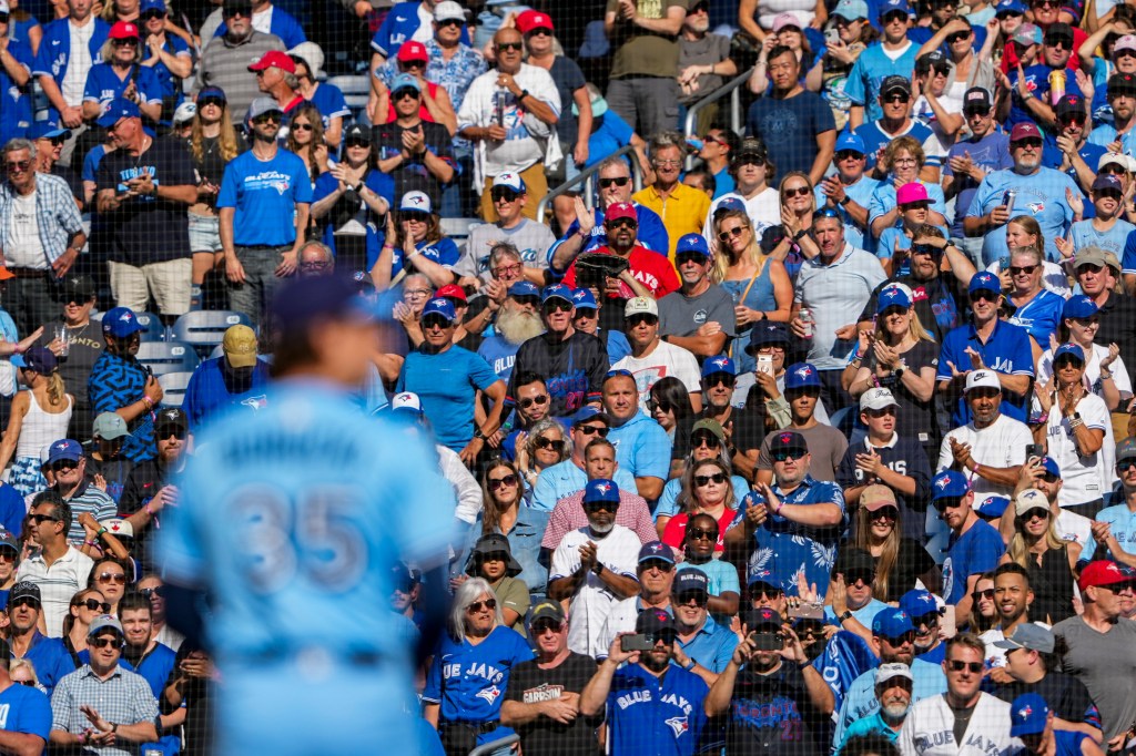 Toronto Blue Jays fans stand up during the ninth inning before pitcher Ryan Borucki (35) sets to pitch to the Baltimore Orioles at Rogers Centre. 