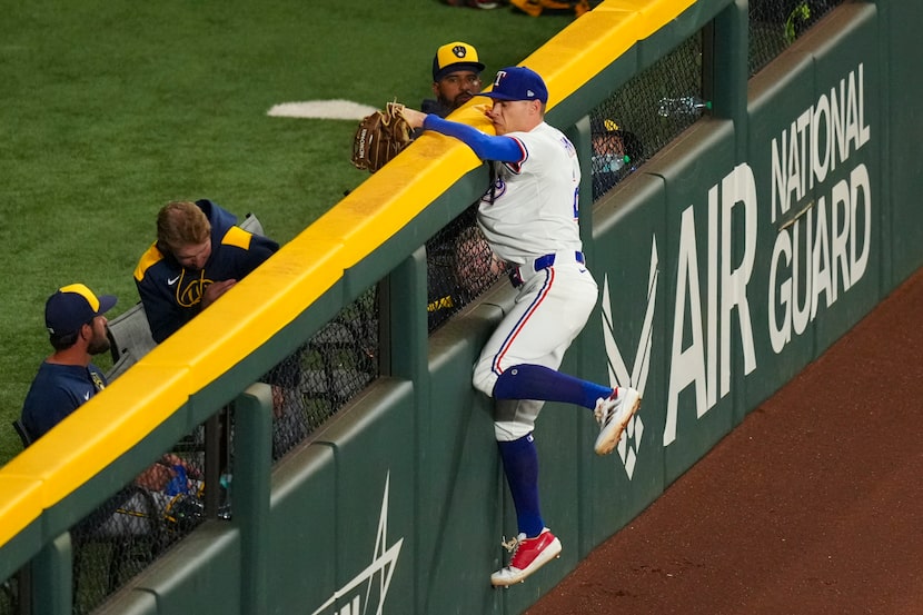 Texas Rangers outfielder Michael Helman robs Milwaukee Brewers' Brice Turang of a home run...