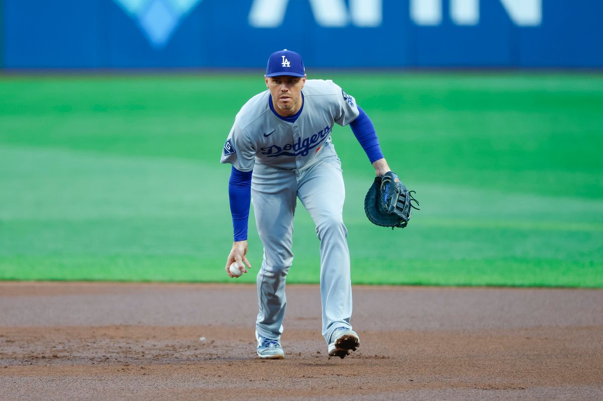 Freddie Freeman #5 flips the ball to first for an out against the Pirates at PNC Park on September 03, 2025 in Pittsburgh.