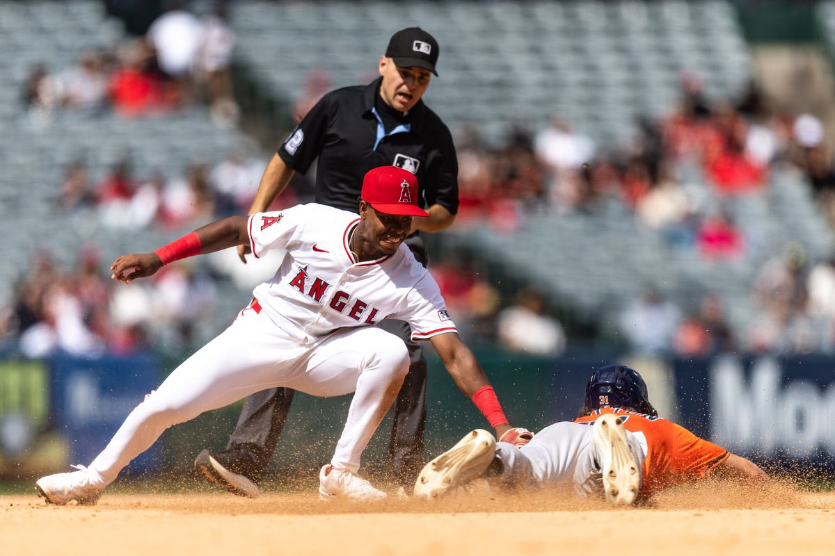 Los Angeles Angels shortstop Denzer Guzman (13) tags out incoming runner from 1st base during the MLB game against the Houston Astros on Sunday, September 28, 2025, at Angel Stadium in Anaheim, Calif.