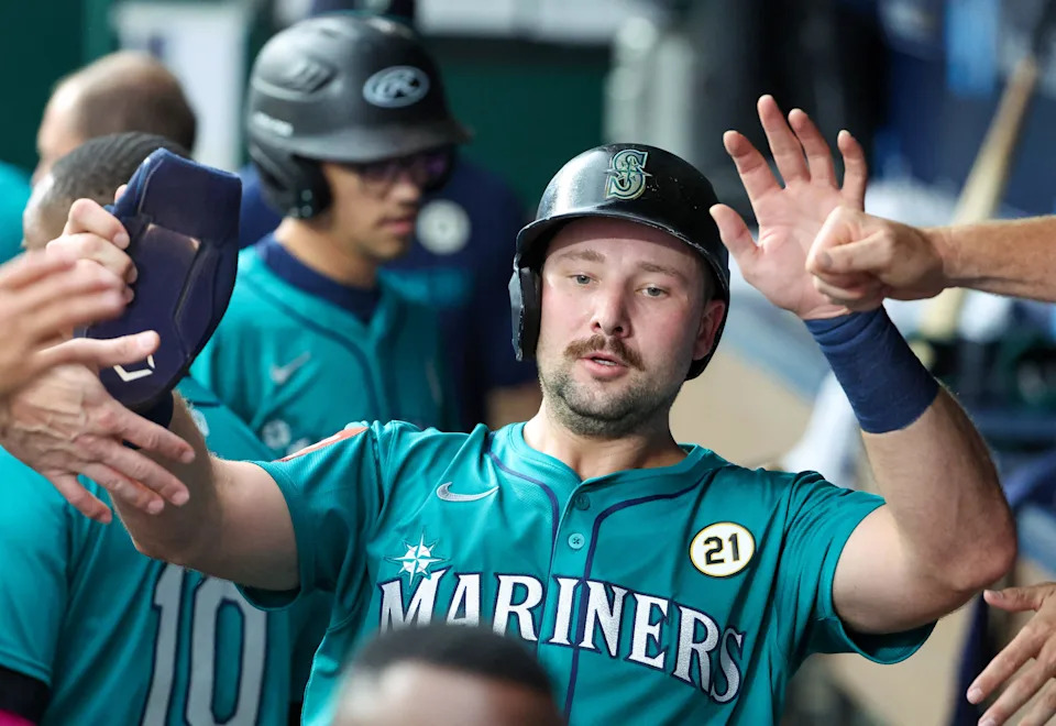 Sep 16, 2025; Kansas City, Missouri, USA; Seattle Mariners catcher Cal Raleigh (29) is congratulated by teammates after hitting a home run in the first inning against the Kansas City Royals at Kauffman Stadium. Mandatory Credit: Scott Sewell-Imagn Images