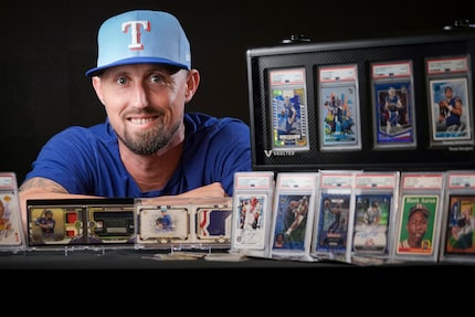 Texas Rangers pitcher Shawn Armstrong with some of his collection of trading cards before a...