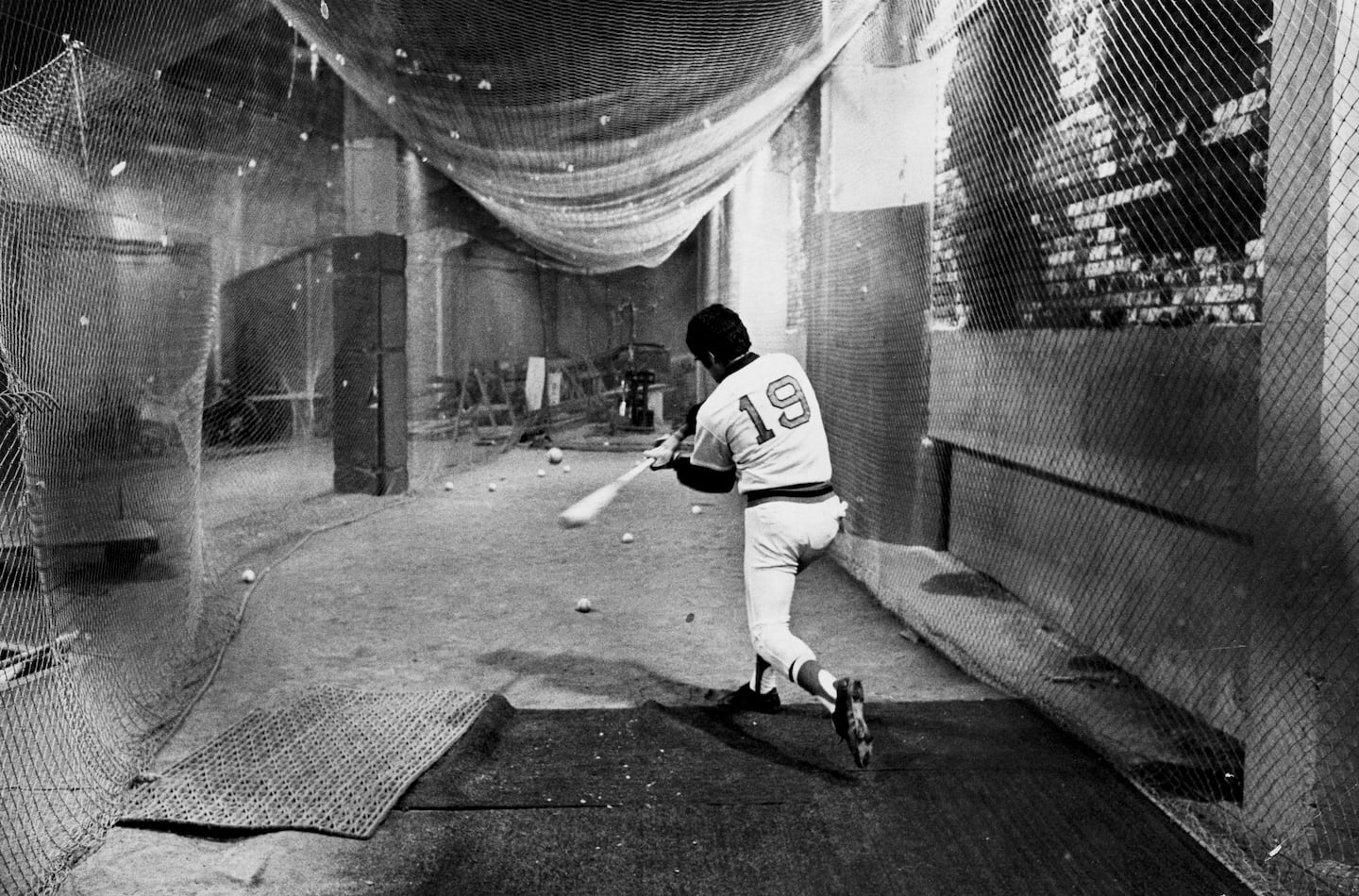 Red Sox center fielder Fred Lynn took batting practice beneath the bleachers at Fenway Park, as Game 6 was postponed a day because of rain.