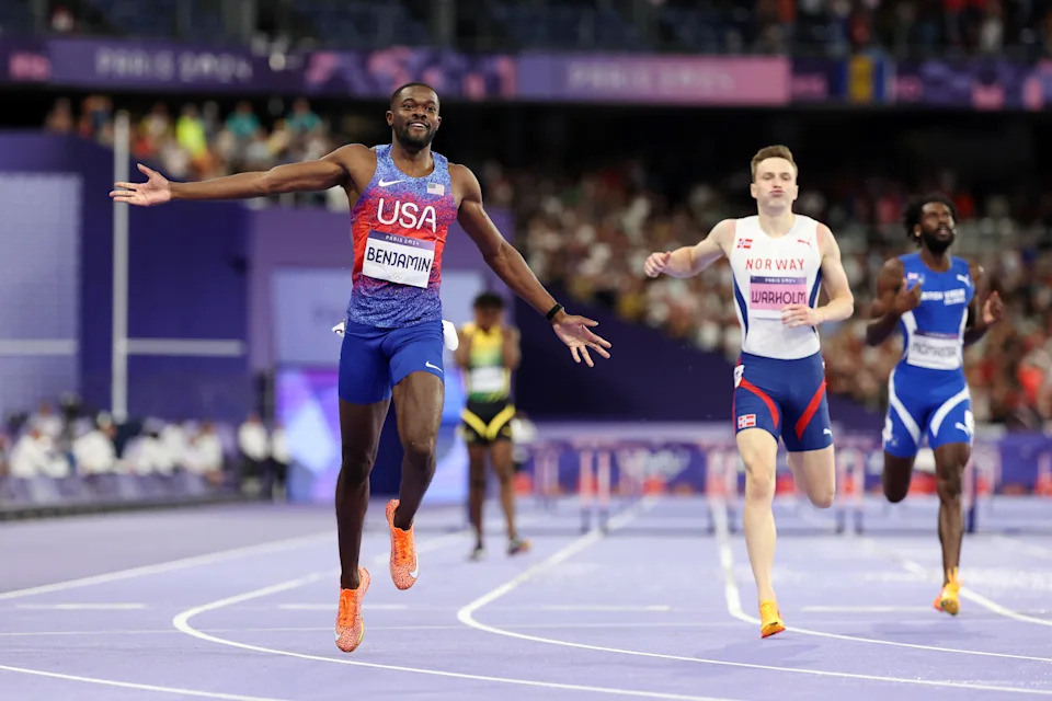 Rai Benjamin celebrates winning Olympic gold over Karsten Warholm last summer. (Hannah Peters/Getty Images)