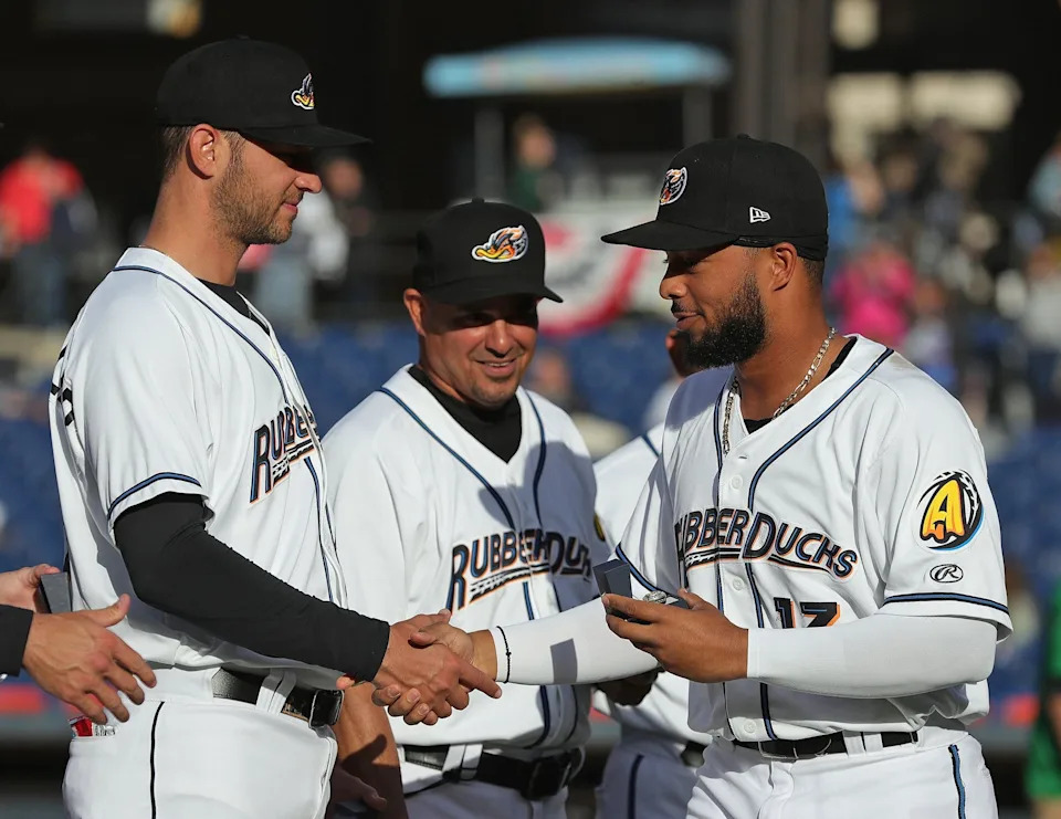 Akron RubberDucks outfielder George Valera (13) shakes hands with his teammates during a ring ceremony before a minor league game at Canal Park on April 12, 2022, in Akron, Ohio.