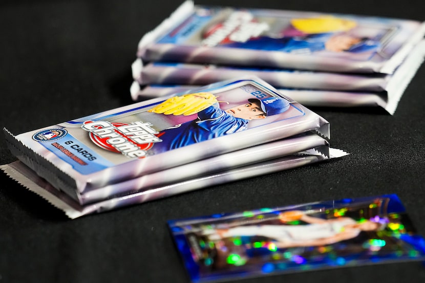 Packages of baseball cards brought to the ballpark by Texas Rangers pitcher Shawn Armstrong...