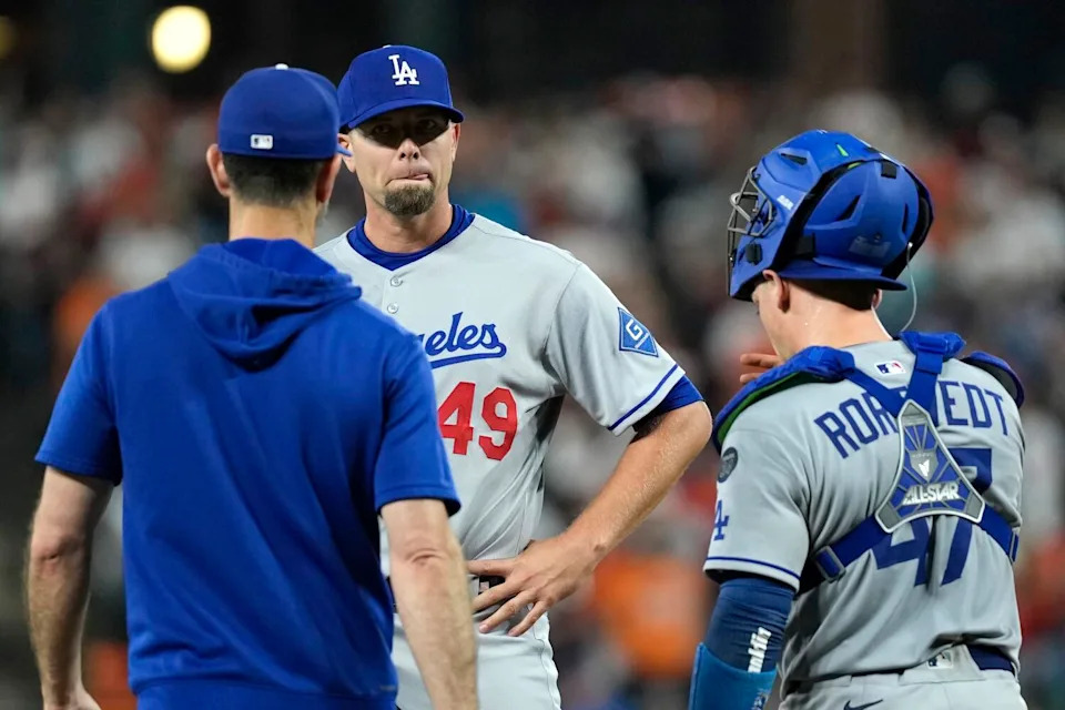 Dodgers reliever Blake Treinen speaks with pitching coach Mark Prior and catcher Ben Rortvedt.