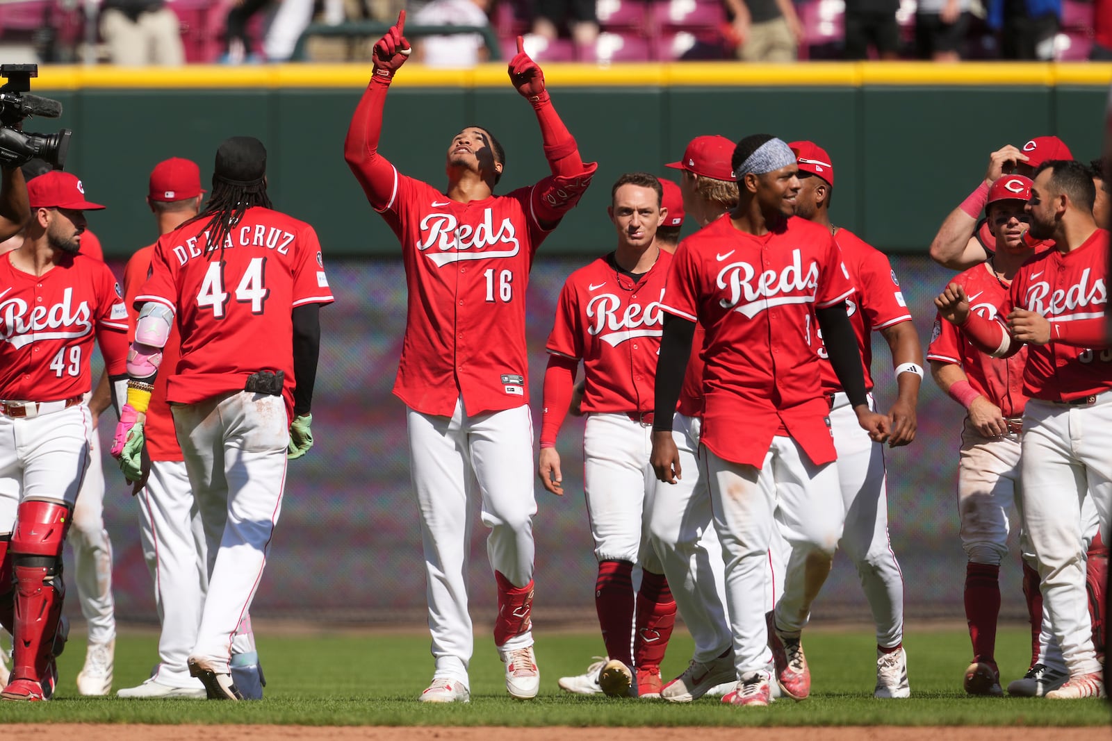 Cincinnati Reds' Noelvi Marte (16) celebrates with teammates after hitting a walkoff two-run single in the ninth inning of a baseball game against the Toronto Blue Jays, Monday, Sept. 1, 2025, in Cincinnati. (AP Photo/Kareem Elgazzar)