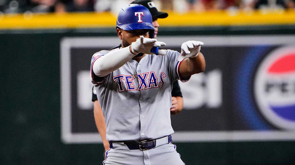 Texas Rangers shortstop Ezequiel Duran (20) celebrates his double in the ninth inning of the game between Arizona Diamondbacks and Texas Rangers at Chase Field. 