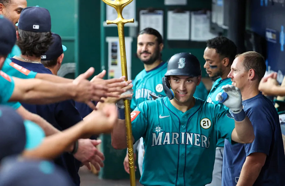 Sep 16, 2025; Kansas City, Missouri, USA; Seattle Mariners right fielder Dominic Canzone (8) is congratulated by teammates after hitting a home run in the second inning against the Kansas City Royals at Kauffman Stadium. Mandatory Credit: Scott Sewell-Imagn Images