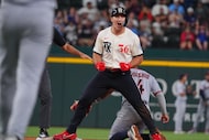Texas Rangers' Wyatt Langford (36) reacts after hitting a double during the ninth inning of...