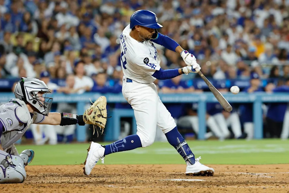 Mookie Betts hits a two-run single in the seventh inning during the Dodgers' 3-1 win over the Rockies on Monday.