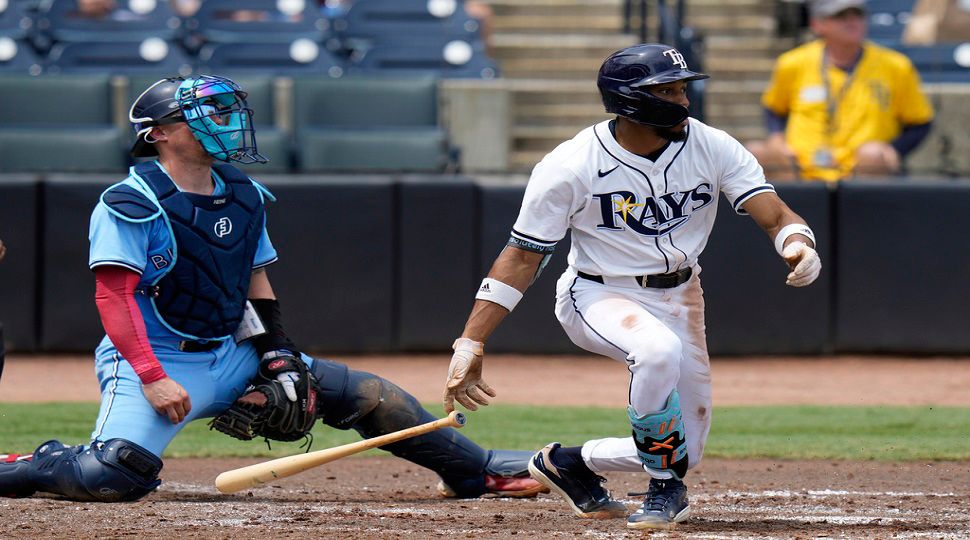 Tampa Bay Rays' Chandler Simpson, right, watches his two-run single off Toronto Blue Jays pitcher Chris Bassitt during the second inning of a baseball game Thursday, Sept. 18, 2025, in Tampa, Fla. Catching for the Blue Jays is Tyler Heineman. (AP Photo/Chris O'Meara)