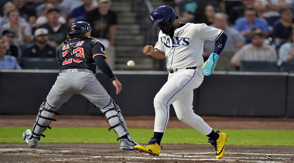 Cleveland Guardians' Austin Hedges (27) and Steven Kwan celebrate after scoring on a two-run double by José Ramírez off Tampa Bay Rays pitcher Ian Seymour during the second inning of a baseball game Friday, Sept. 5, 2025, in Tampa, Fla. (AP Photo/Chris O'Meara)