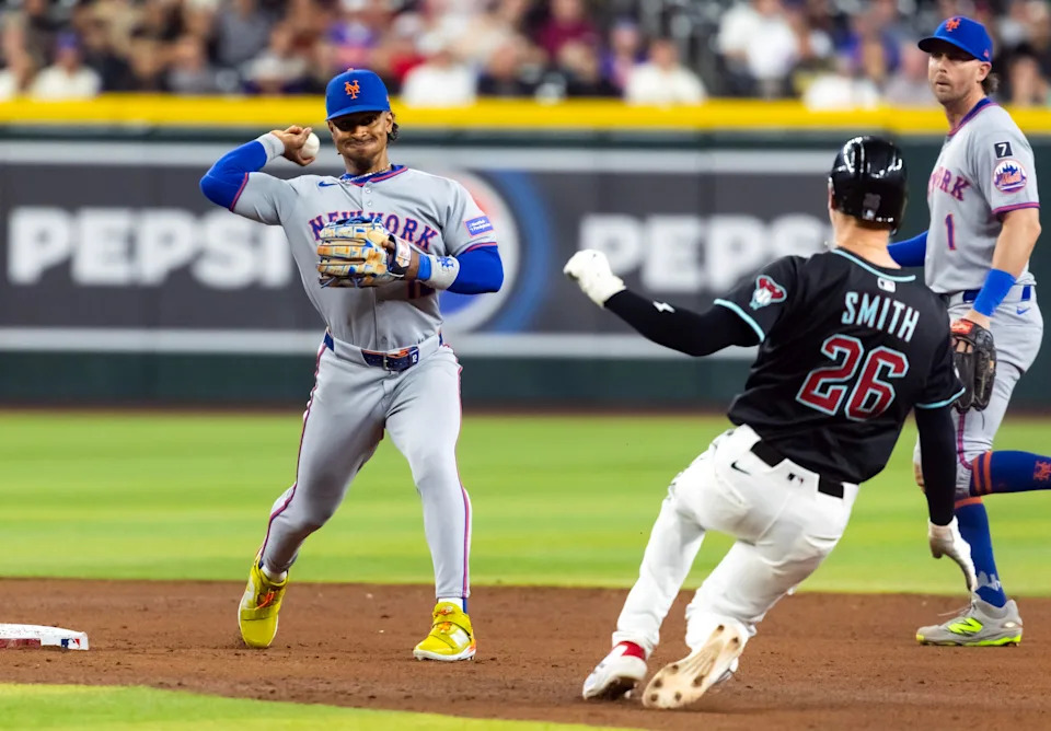 May 5, 2025; Phoenix, Arizona, USA; New York Mets shortstop Francisco Lindor (left) against Arizona Diamondbacks base runner Pavin Smith at Chase Field. Mandatory Credit: Mark J. Rebilas-Imagn Images