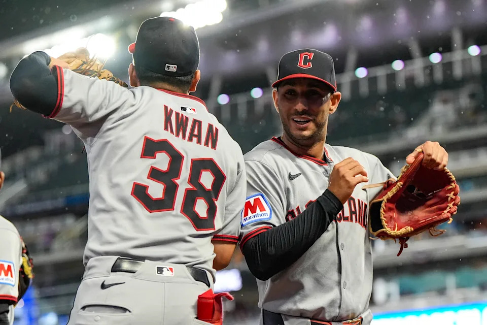 Cleveland Guardians' Steven Kwan (38) and Brayan Rocchio celebrate in the eighth inning of a baseball game against the Minnesota Twins, Friday, Sept. 19, 2025, in Minneapolis. (AP Photo/Mike Stewart)