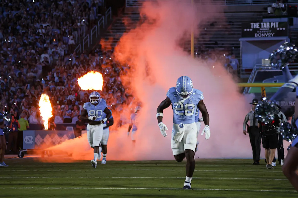 Tar Heels players run out onto the field. (Nicholas Faulkner/Icon Sportswire via Getty Images)