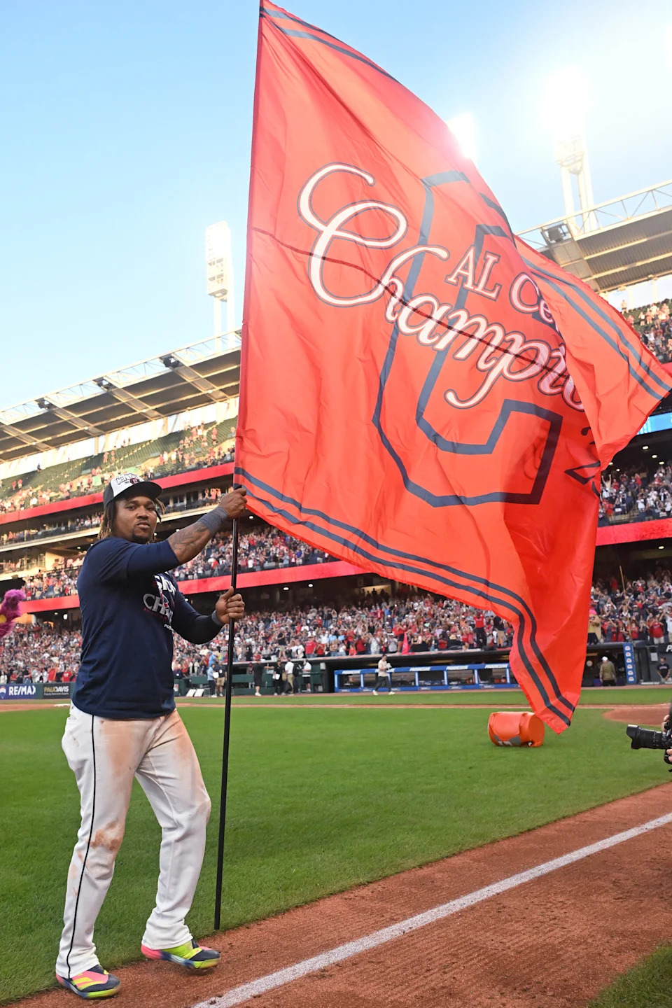 Cleveland Guardians third baseman Jose Ramirez plants the flag after the Guardians beat the Texas Rangers and won the American League Central Division on Sept. 28, 2025, in Cleveland.