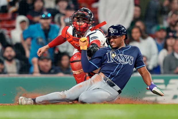 Tampa Bay Rays' Richie Palacios scores against Boston Red Sox catcher Connor Wong on a single by Jose Siri during the sixth inning of a game Wednesday in Boston. (AP Photo/Michael Dwyer)