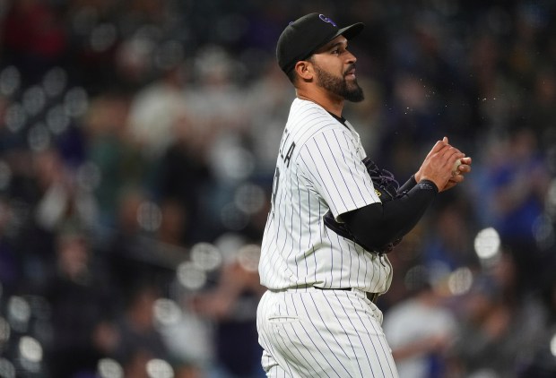 Colorado Rockies starting pitcher Antonio Senzatela rubs a new ball after giving up a three-run home run to Milwaukee Brewers' Jackson Chourio in the fifth inning of a baseball game Wednesday, April 9, 2025, in Denver. (AP Photo/David Zalubowski)