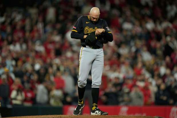 Pirates pitcher Tim Mayza adjusts his hat in an April 12 game against Cincinnati. (AP Photo/Carolyn Kaster)