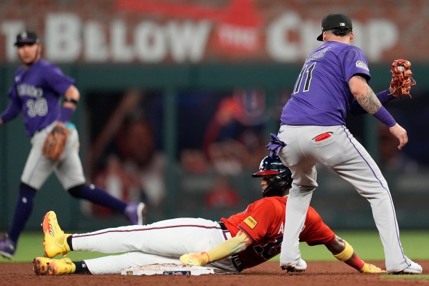 Atlanta Braves' Ronald Acuña Jr. (13) steals second base against Colorado Rockies shortstop Orlando Arcia (11) in the fifth inning of a baseball game, Friday, June 13, 2025, in Atlanta. (AP Photo/Mike Stewart)