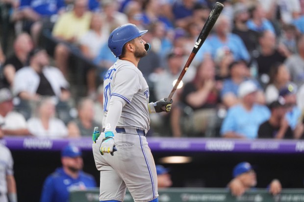 Toronto Blue Jays' Bo Bichette follows the flight of his two-run home run off Colorado Rockies relief pitcher Ryan Rolison in the third inning of a baseball game Monday, Aug. 4, 2025, in Denver. (AP Photo/David Zalubowski)