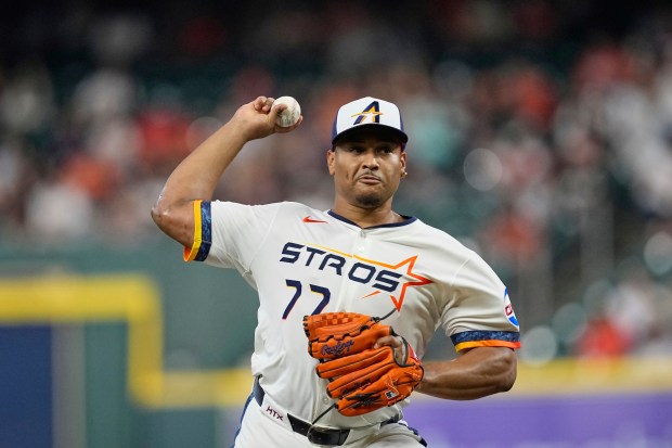 Houston Astros starting pitcher Luis Garcia throws to the plate...