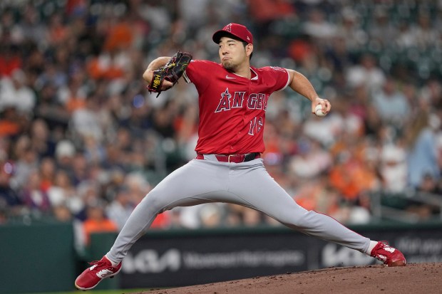 Angels starting pitcher Yusei Kikuchi throws to the plate during...